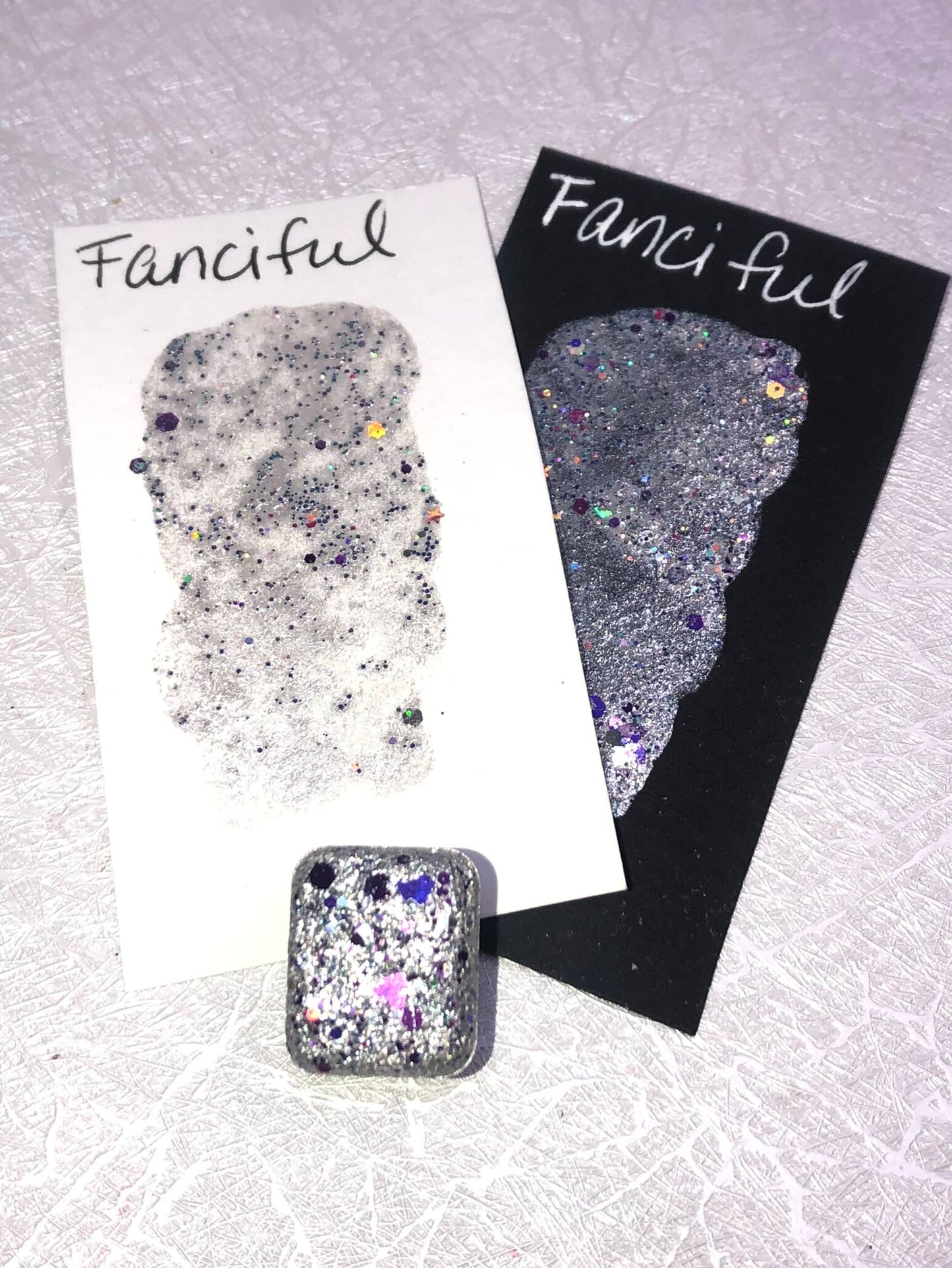 Fanciful shimmer watercolor paint half pan with swatch photo